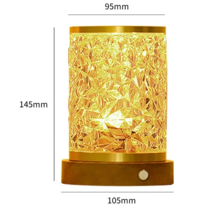 Small rotating water ripple night light with a solid wood base and acrylic body on a bedside table.