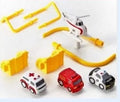 Plastic toy car track with handle remote control and colourful trolley vehicles on parking lot rails