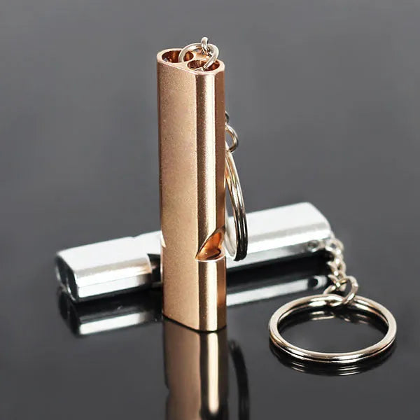 Silver or gold coloured aluminium alloy double hole outdoor survival whistle.