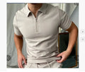 Man wearing a navy blue digital print polo shirt with short sleeves and a loose fit.
