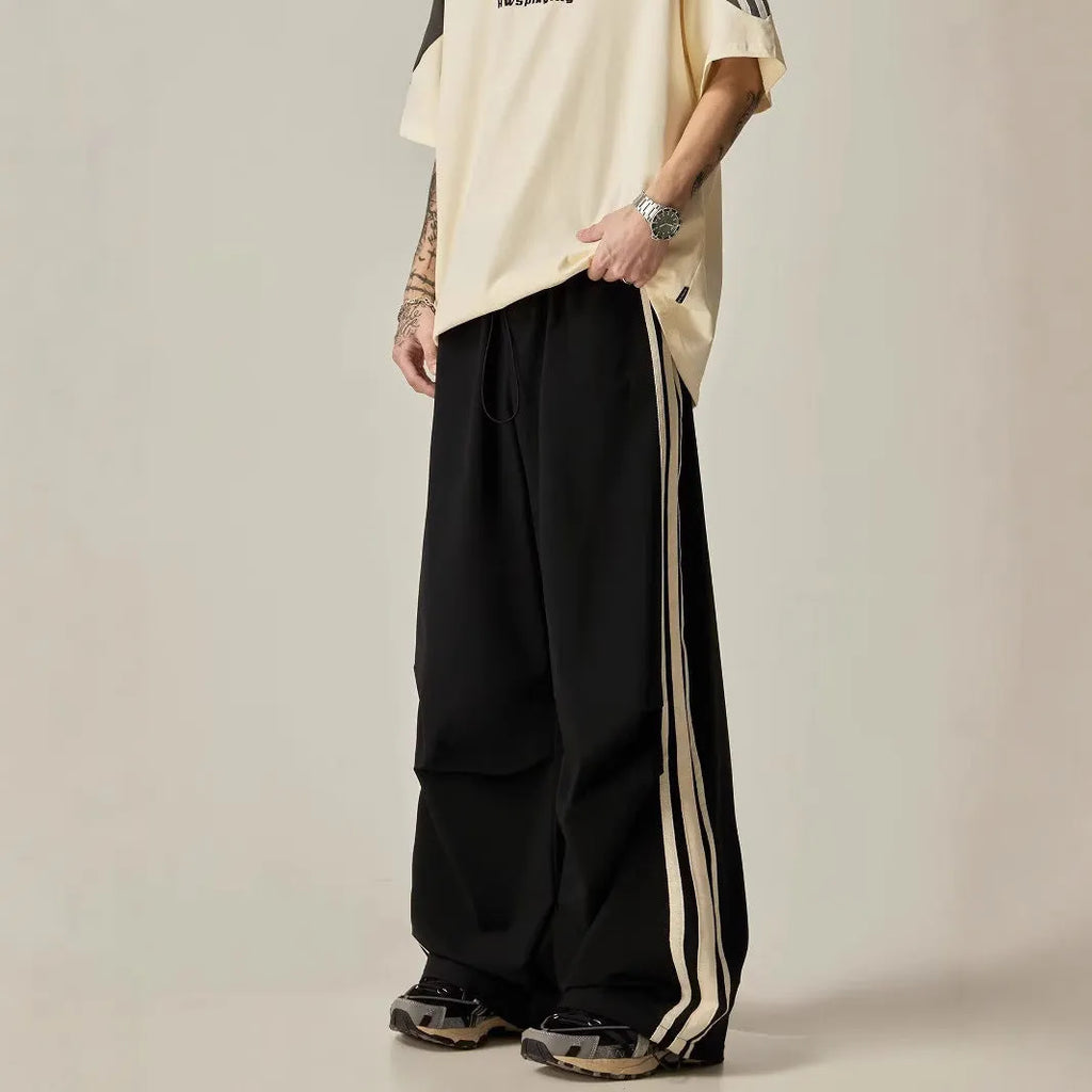 Black high-waisted wide leg straight trousers for men, made from polyester fibre.