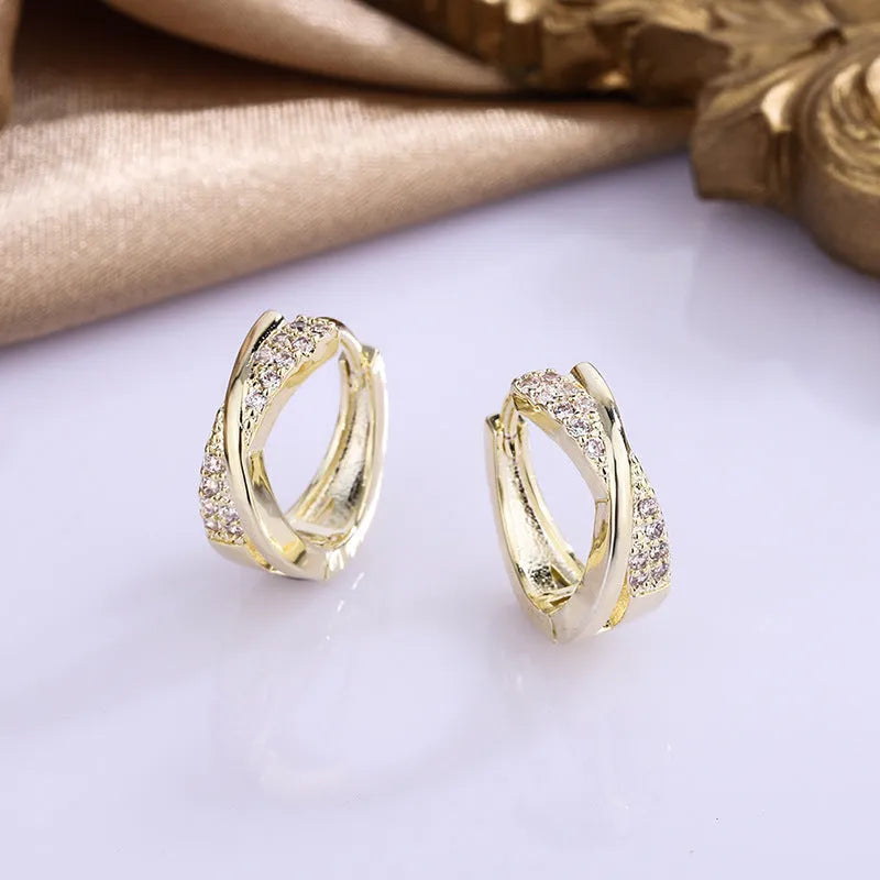 Geometric shape earrings with zircon detail and 14K yellow gold finish on copper