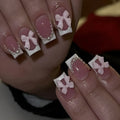 Short white French tip false nails with cute bow and starry sky designs, shown with glue bottles.