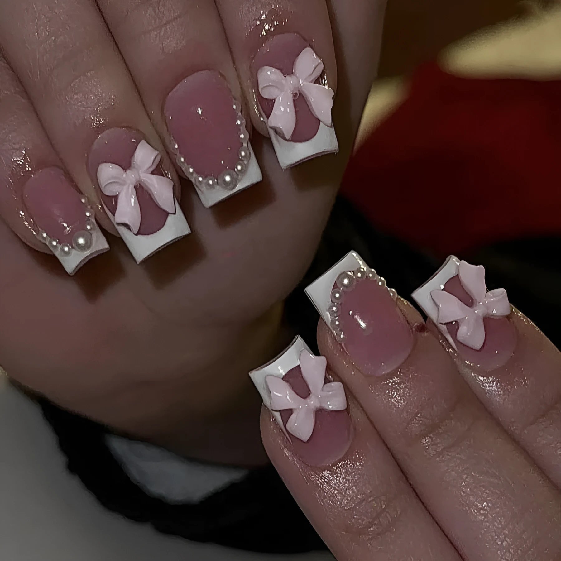 Short white French tip false nails with cute bow and starry sky designs, shown with glue bottles.