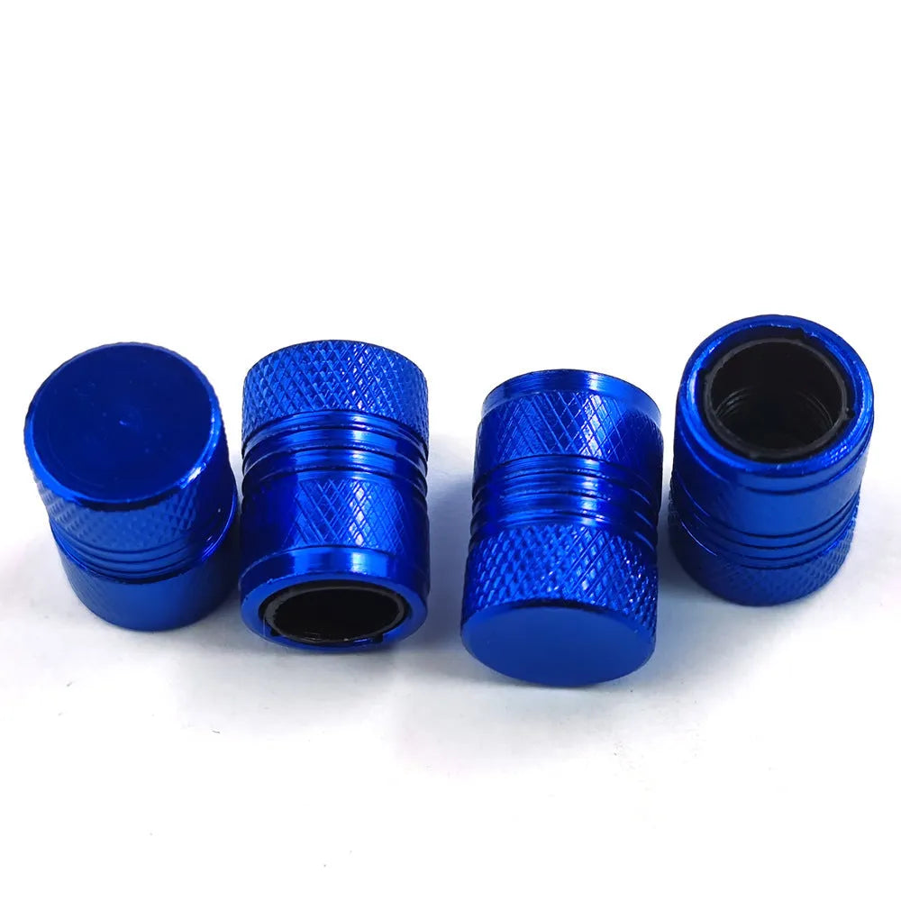 Aluminium car tyre valve dust cap in black, blue, grey, and red colours.