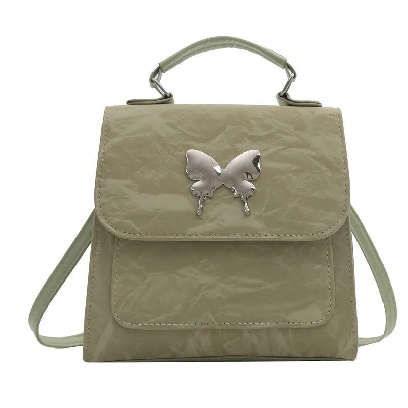 Women's preppy style PU hand-carry backpack with bow detail in light blue colour