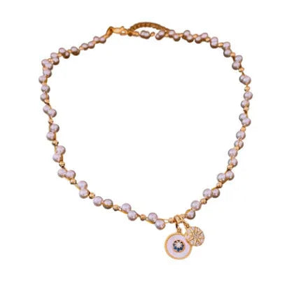 Gold electroplated women's clavicle necklace with round zircon pearl pendant on white background