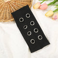 Hollow metal punk hair band with circle decoration in seven colour options on a white background.