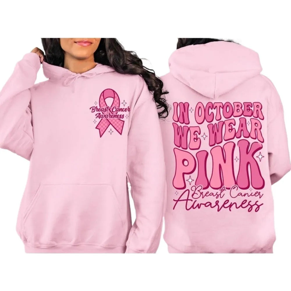 Pink breast cancer awareness hoodie with retro pattern and side pocket on a hanger.