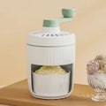 Hand-cranked ice shaving machine in green or orange with removable ice box, PP ABS and 304 stainless steel construction