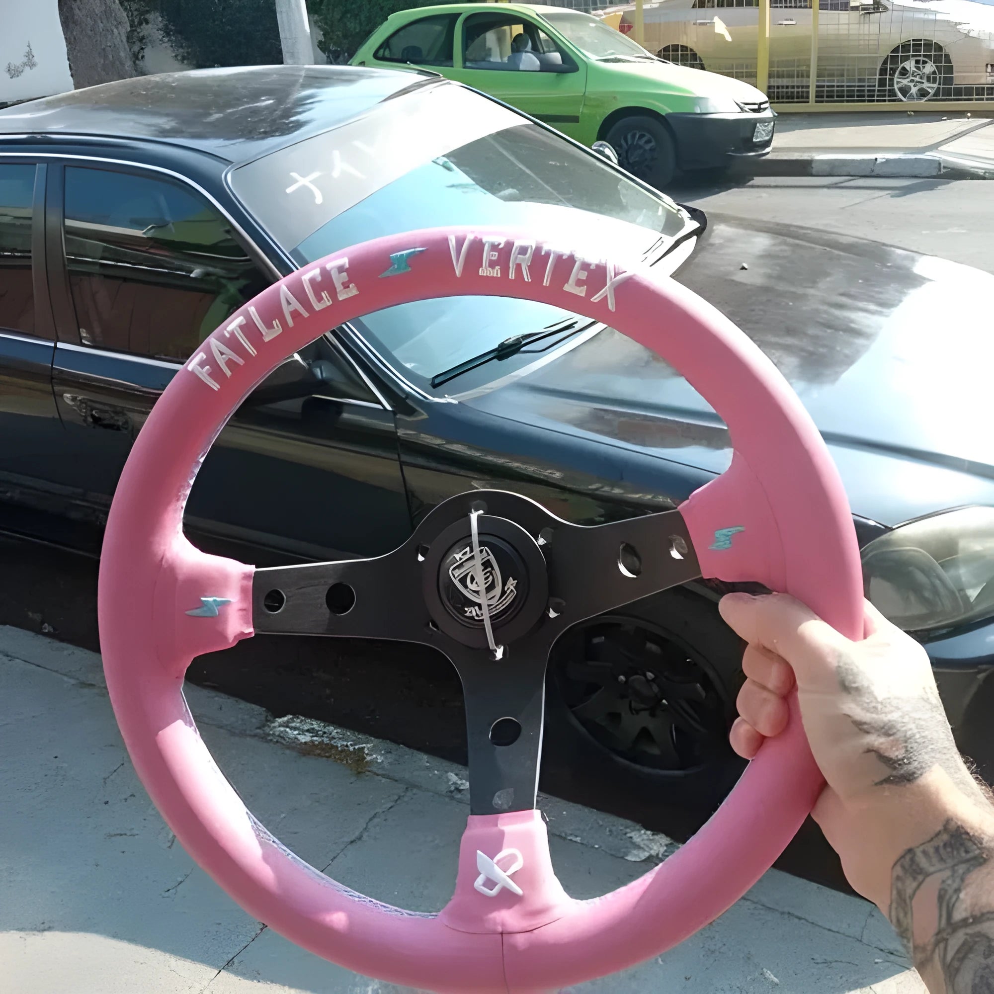Pink leather steering wheel cover with embroidery, showing integrated aluminium alloy bracket.