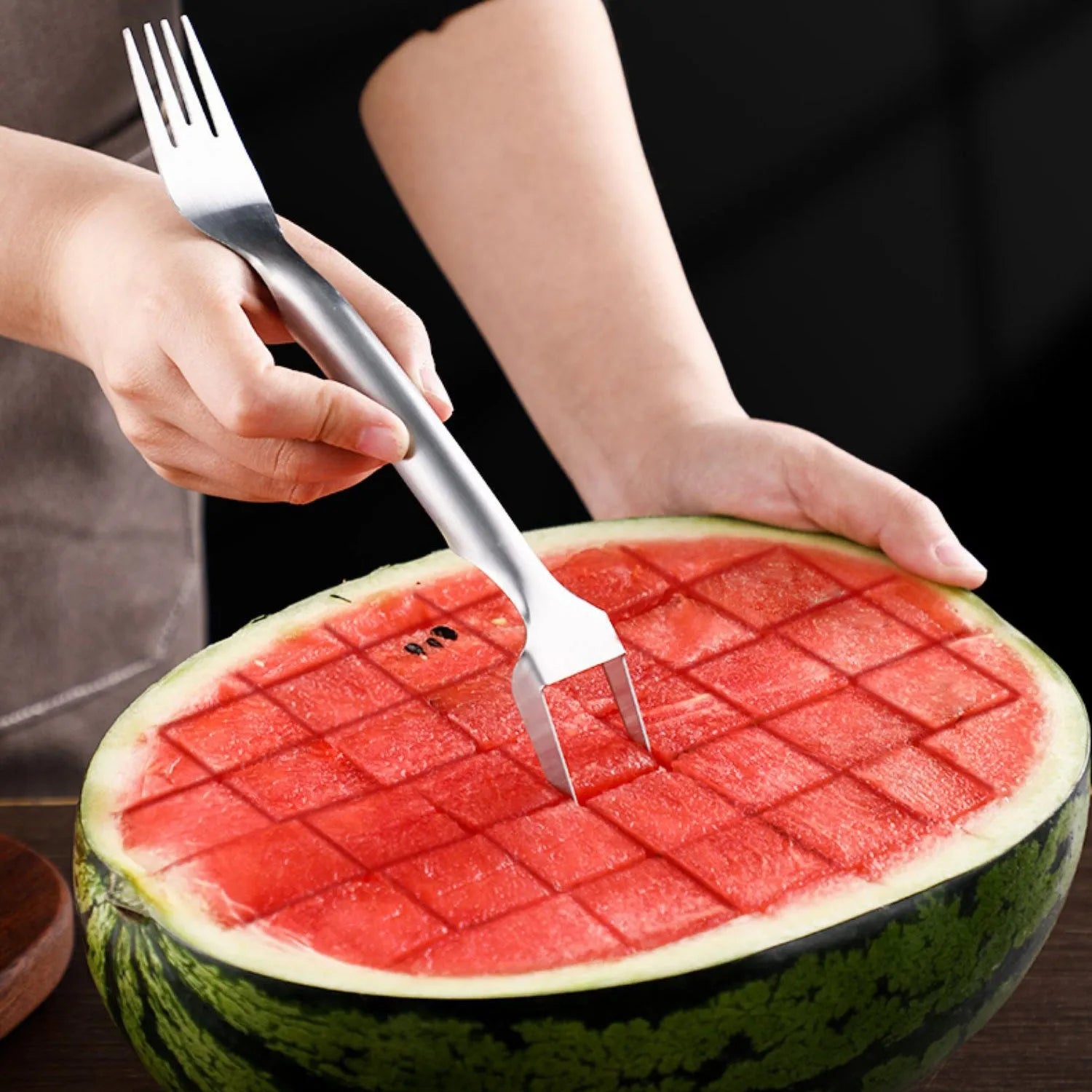 Silver stainless steel watermelon fork slicer with extended handle and rounded fork head