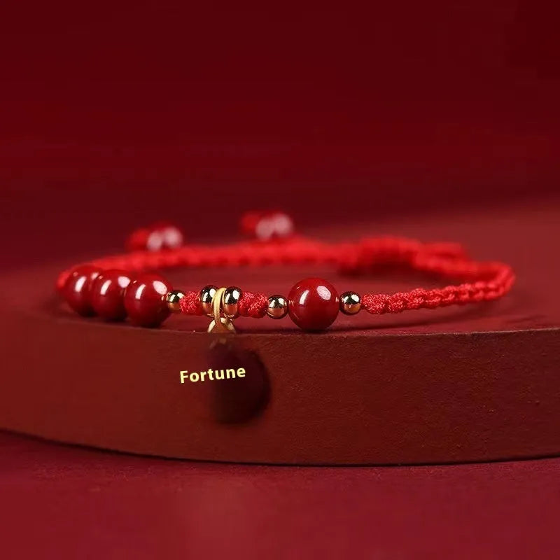 Cinnabar braided rope bracelet with blessing card, shown in black, red, or wine red with round bead or flower charm.