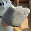 Blue plush PVC winter slipper with non-slip sole and car stitching detail on a wooden floor.