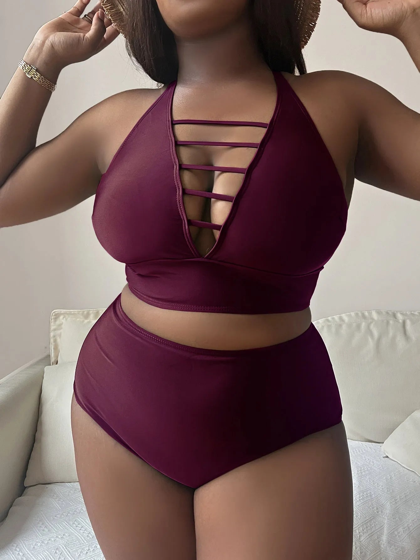 Plus size woman in a solid colour halter neck bikini with adjustable cross-back straps and high-waisted briefs.