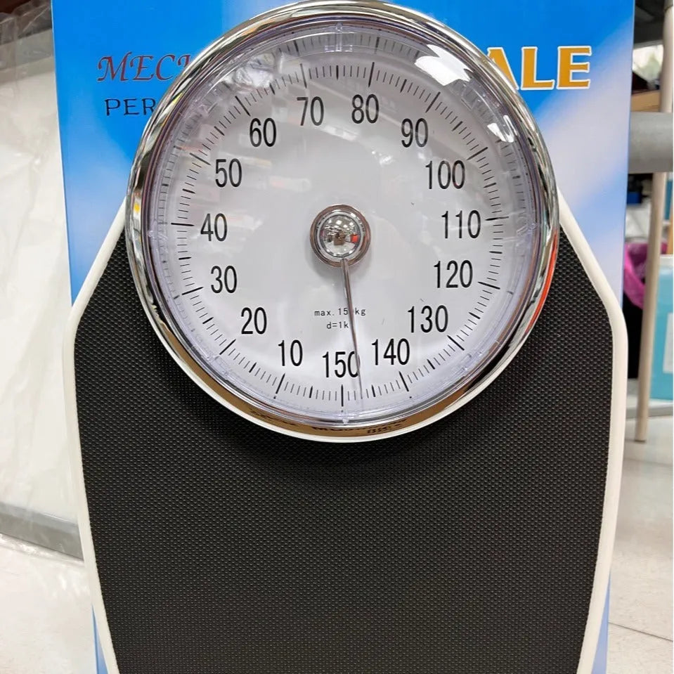 Black mechanical body weight scale with large analogue dial showing pointer display.