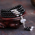 Black agate 108 bead unisex geometric bracelet with number elements.