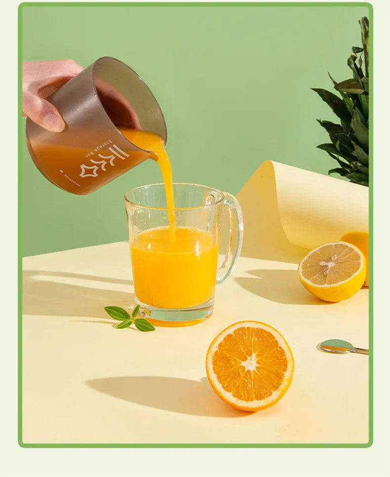 White manual citrus juicer with cup for squeezing lemons and oranges, showing three-part design