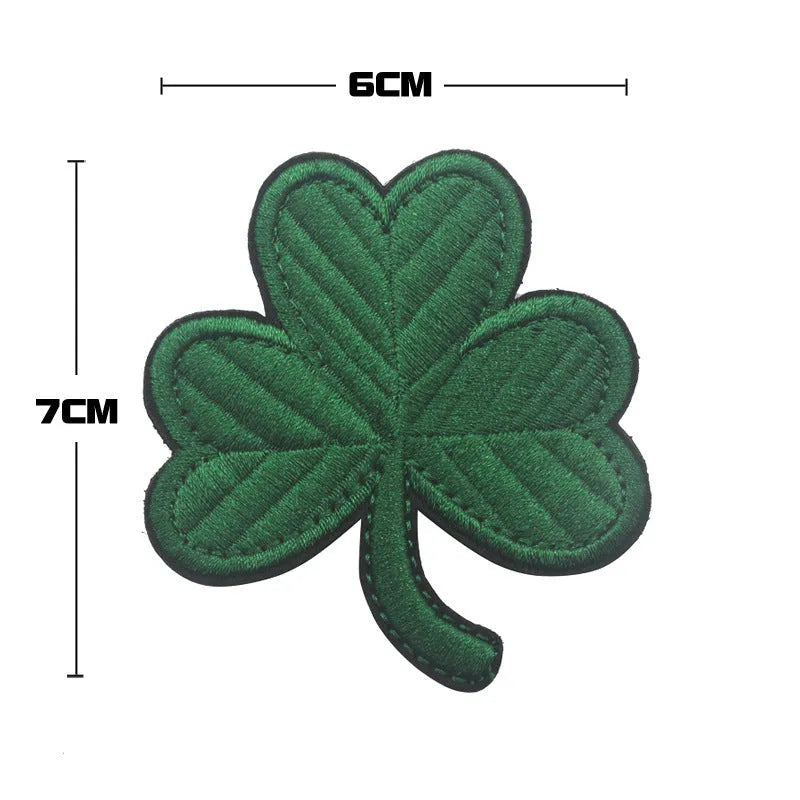 Embroidered fabric badge with Velcro strip showing clover design in green colour