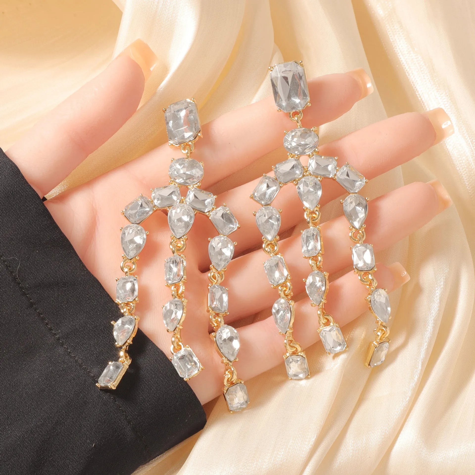 Heavy-duty full-drop diamond teardrop fringe earrings in zinc alloy, green colour, on display