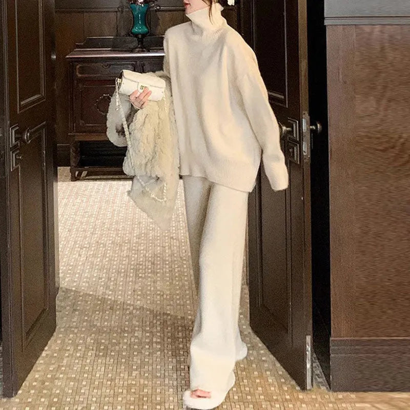 Women's beige acrylic fibre sweater and wide-leg trousers two-piece set on a hanger.
