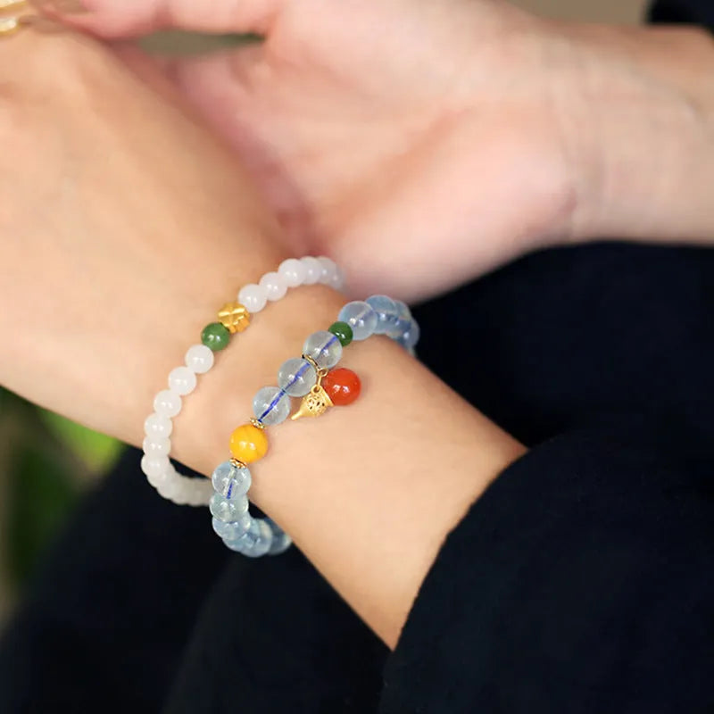 Geometric women's bracelet with 8mm iced aquamarine stones on a wrist.