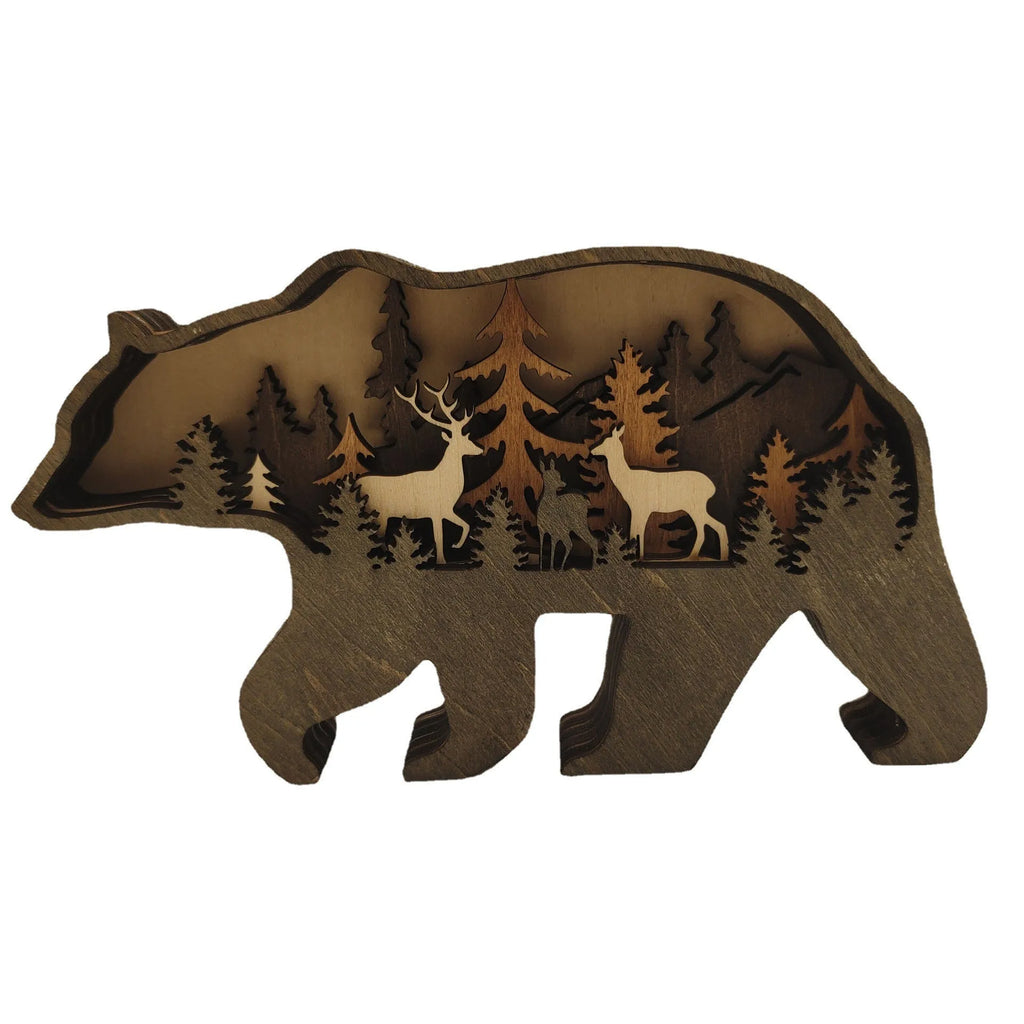 Two boxwood wooden ornaments, elk and brown bear, on a flat surface with natural wood finish