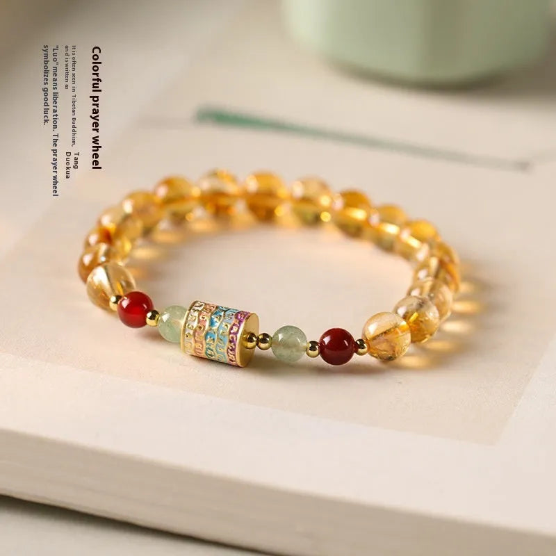 Yellow citrine bracelet with prayer wheel charms and 8mm round beads