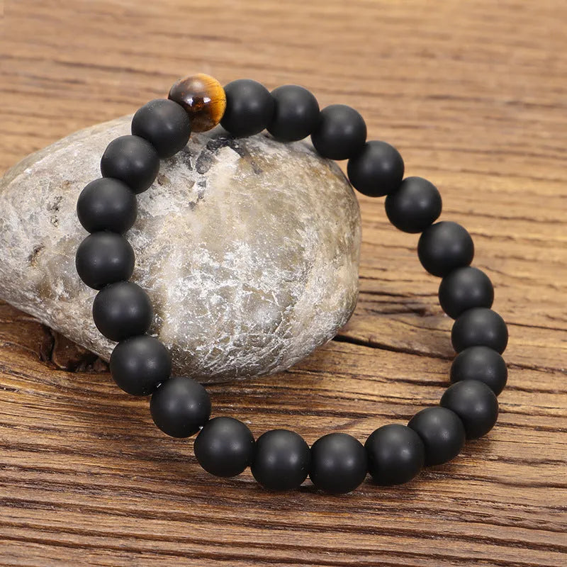 Tiger eye stone beaded necklace and bracelet set with tassel pendants on white background