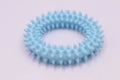 Blue TPR spiky circle ring dog chew toy on a white background.