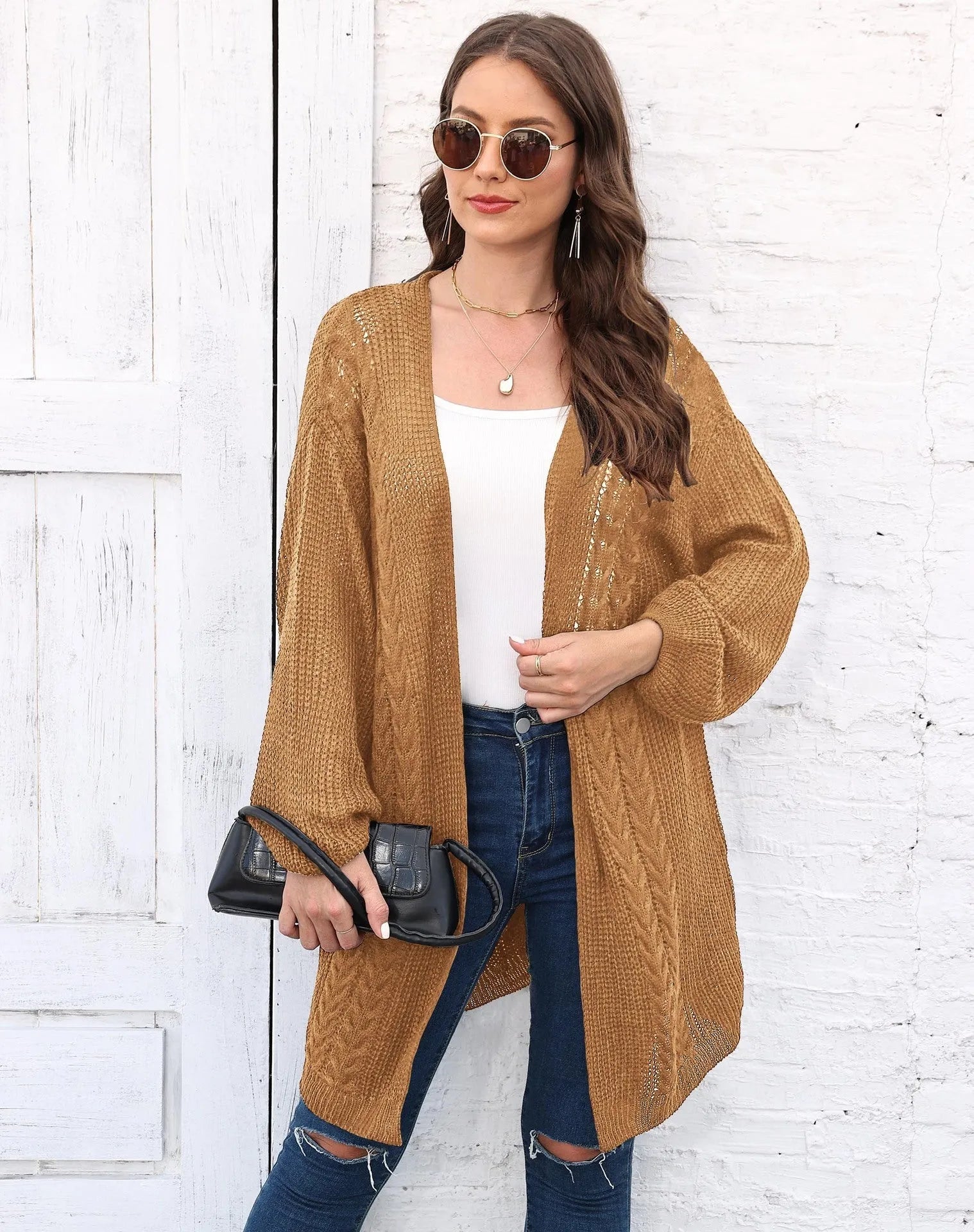 Women's loose-fit acrylic sweater coat in a solid colour, shown in light grey.