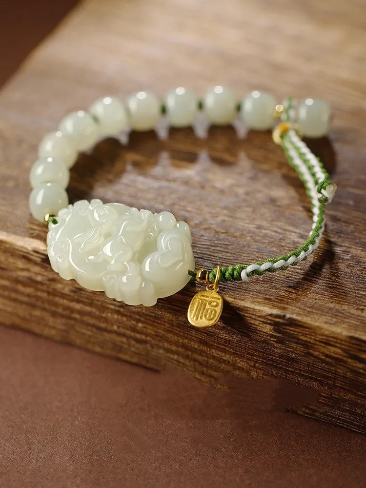 Rabbit Chinese zodiac bracelet with Hetian jade charm and silver card on a red rope.