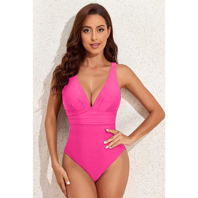 Minimalist solid colour cross-shoulder one-piece swimsuit for women on a mannequin.