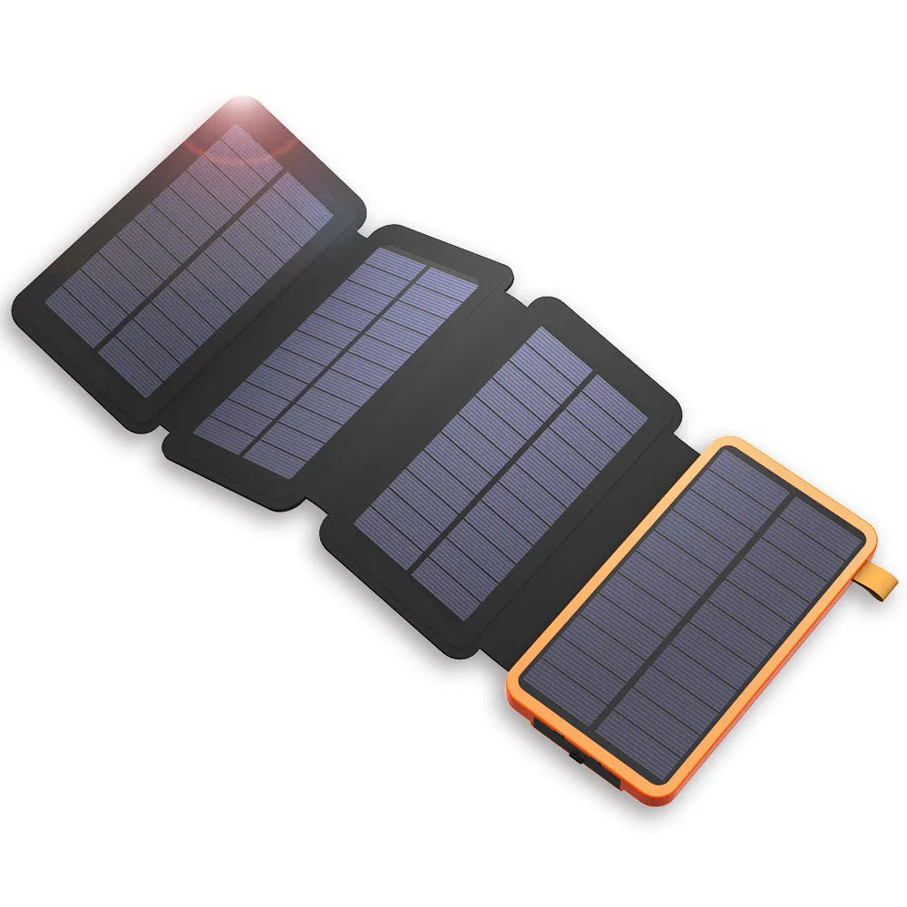 Black outdoor solar power bank with a solar panel and a built-in LED light displayed on a rock.