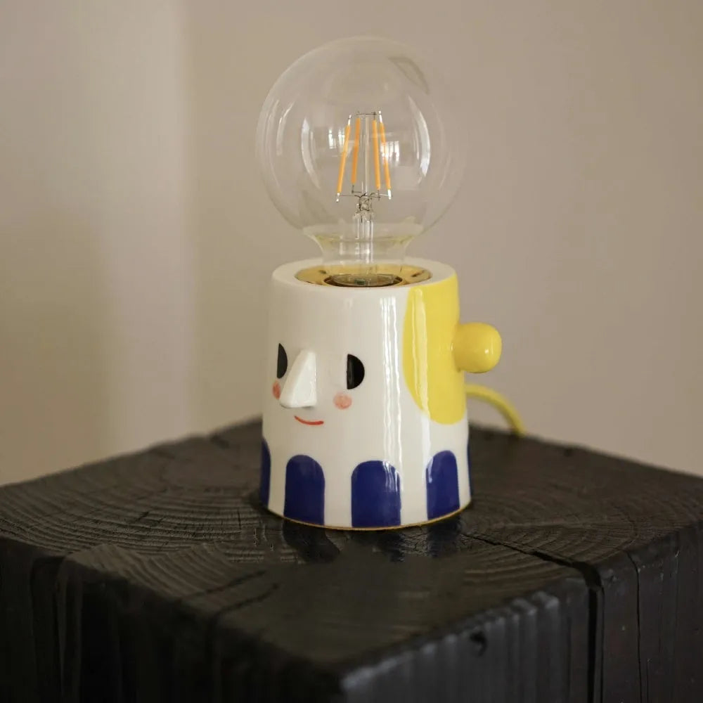 Handmade ceramic table lamp with a spherical ball headlight design on a solid ceramic base.