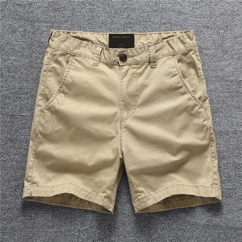 Youth cotton workwear shorts in camouflage green pattern with mid waist and zip fly.