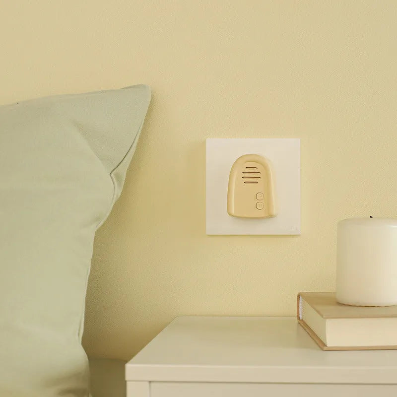 Wireless plug-in doorbell in milky yellow or white colour for household use