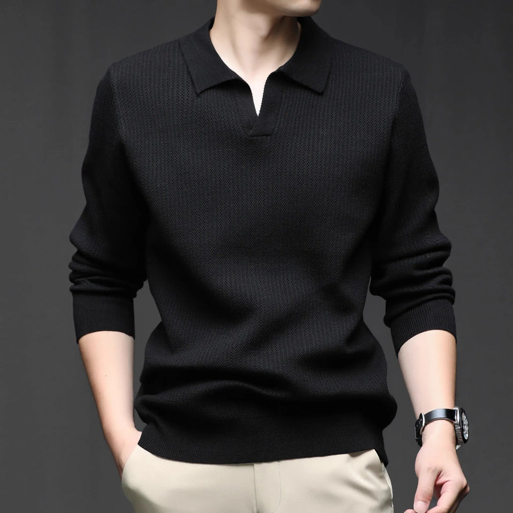 Man wearing a loose green casual pullover sweater, showing the simple long-sleeve design.