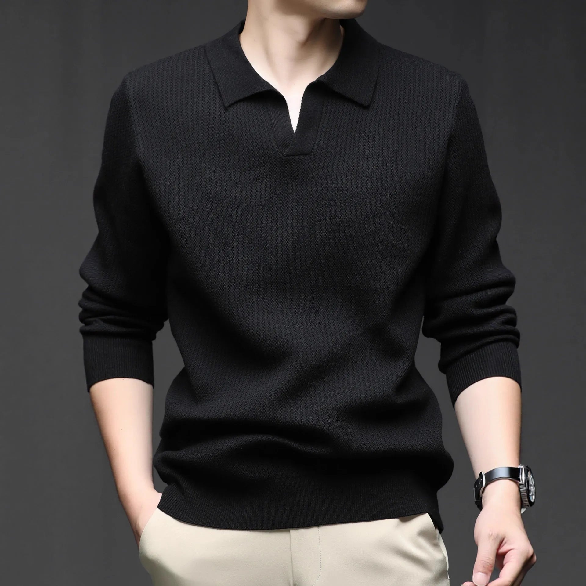 Man wearing a loose green casual pullover sweater, showing the simple long-sleeve design.