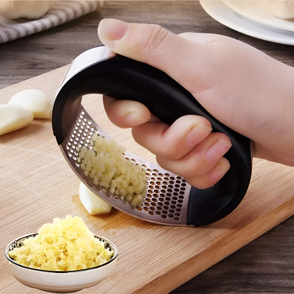 Stainless steel garlic press with non-slip handle in available colours crushing garlic