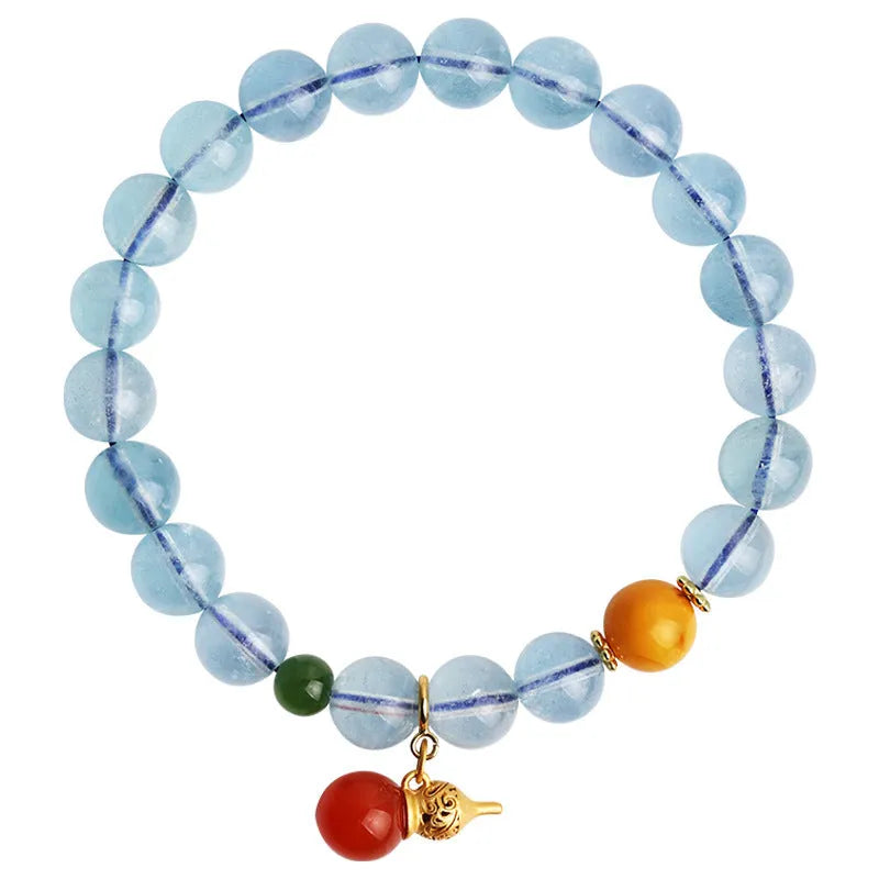 Geometric women's bracelet with 8mm iced aquamarine stones on a wrist.