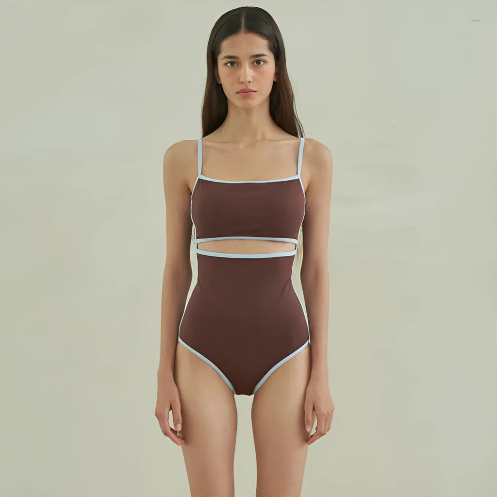 Brown women's one-piece swimsuit with a triangle pattern top on a hanger.