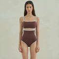 Brown women's one-piece swimsuit with a triangle pattern top on a hanger.