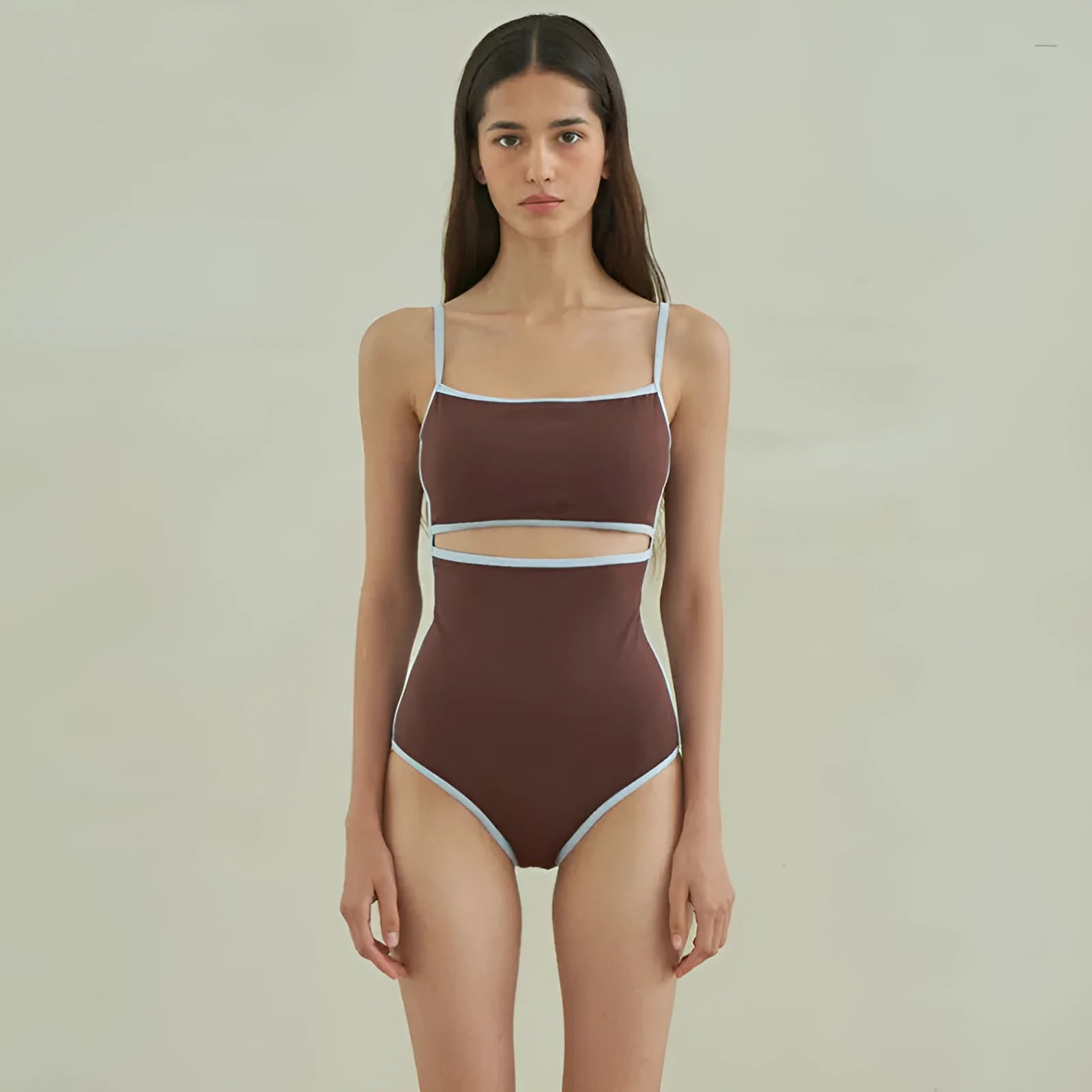 Brown women's one-piece swimsuit with a triangle pattern top on a hanger.