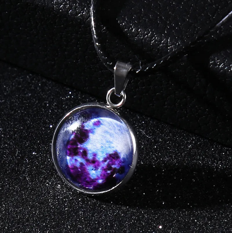 Luminous moon and constellation glass pendant on a silver alloy necklace chain with an extension piece.