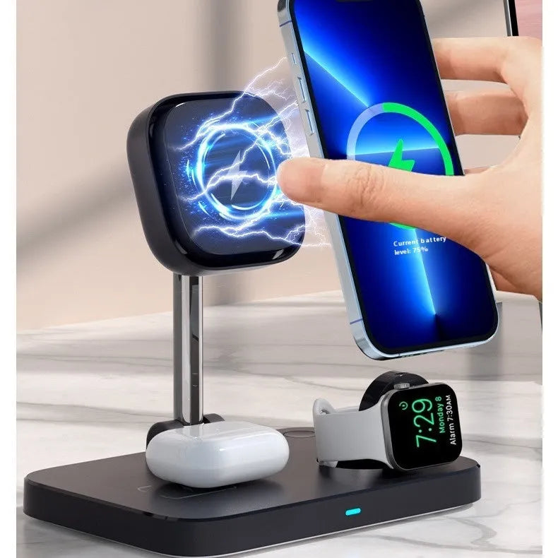Black magnetic three-in-one wireless charger and cooling bracket on a desk, with phone upright and watch on base.