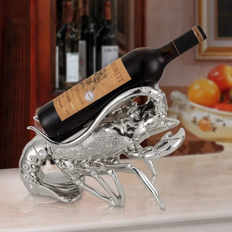 Lobster-shaped wine rack ornament in rose gold holding a wine bottle