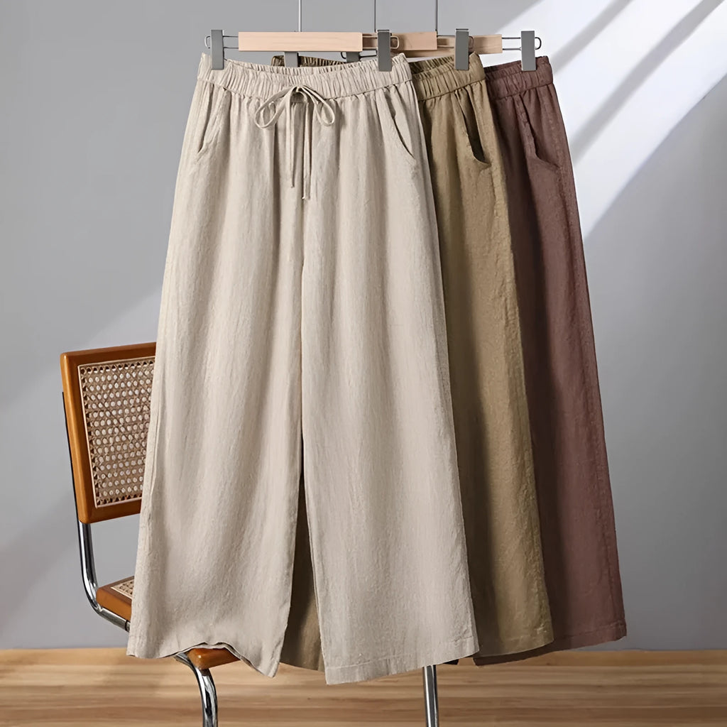 Women's apricot straight-leg casual trousers with elastic waist and front drawstring detail.