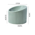 Elevated ceramic cat bowl in dark green colour showing tilted round design