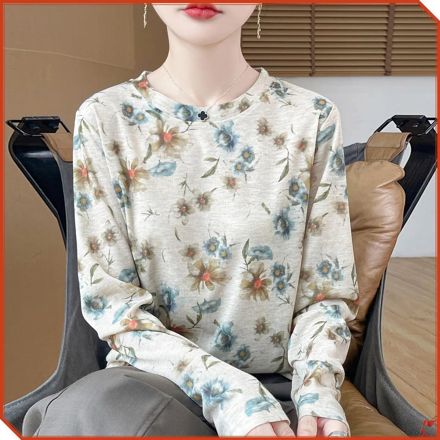 Round neck Tencel cotton pullover shirt with a colourful floral print, shown on a hanger.